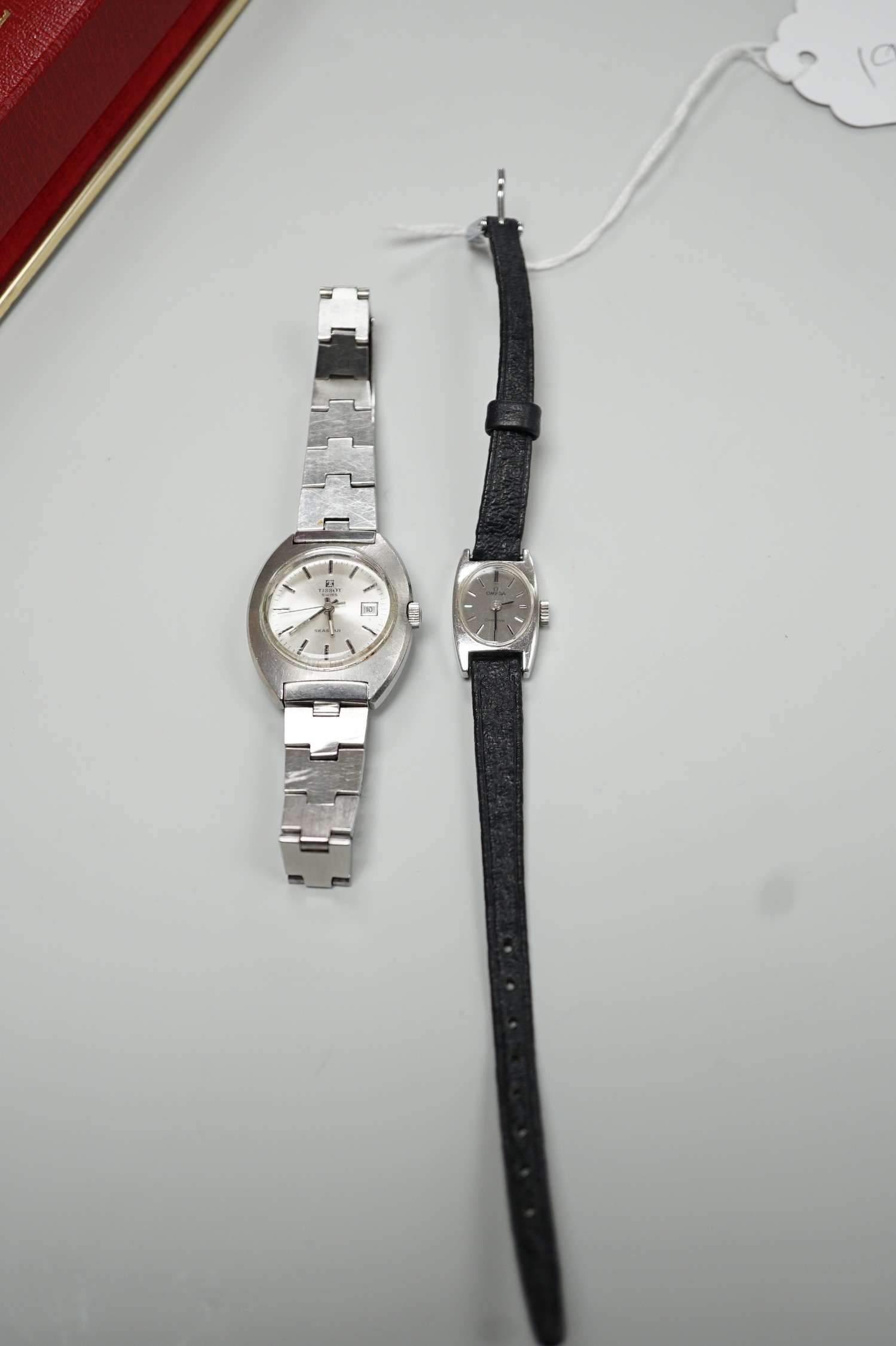 A lady's stainless steel Omega manual wind wrist watch, case diameter 16mm, with Omega box and a similar Tissot wrist watch.